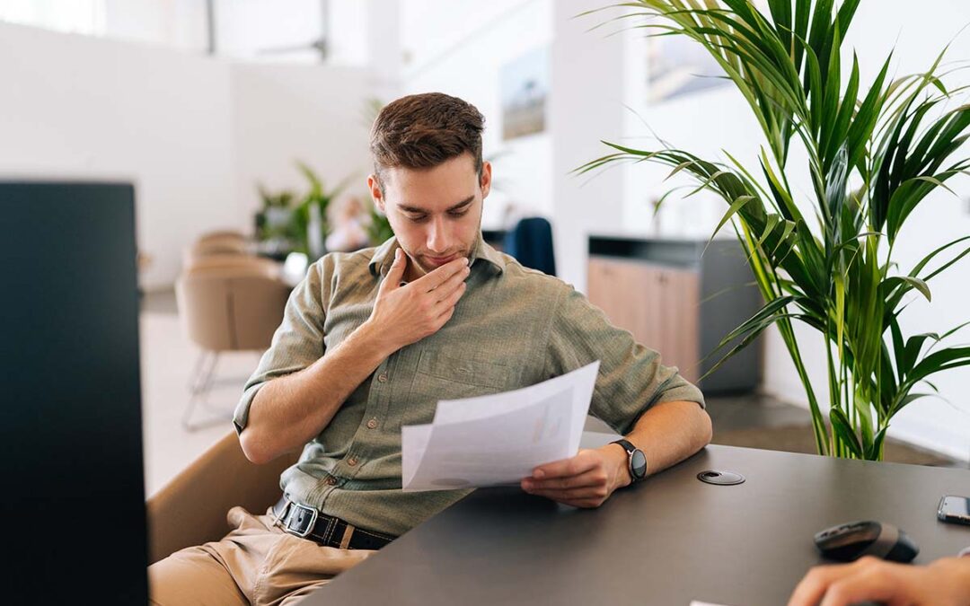 Portrait of focused male client reading contract